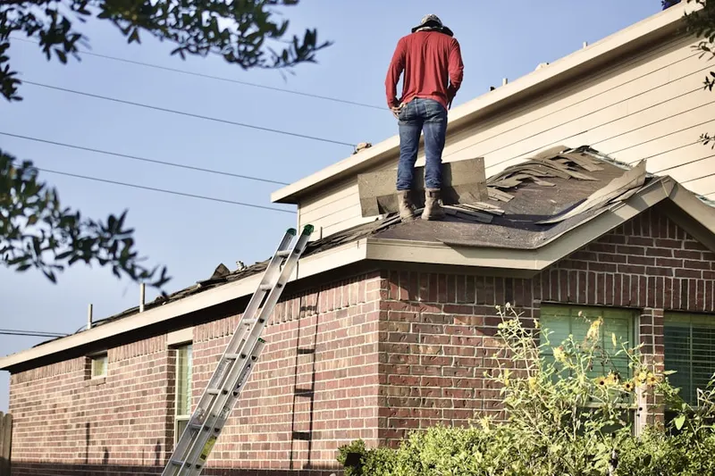 Professional roofer working on a residential roof in Christensen